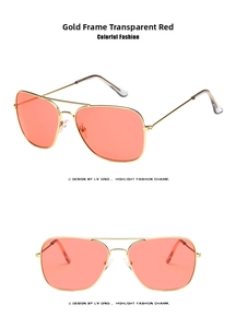 Detail view of aviator sunglasses with gold metal frame and transparent red lenses