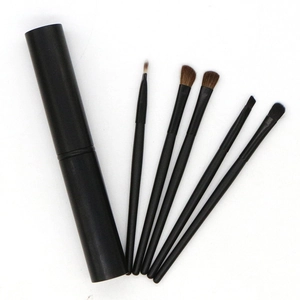 Set of 5 pony hair eye makeup brushes in a black cylindrical travel storage tube