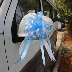 Close-up of blue and white spherical ribbon bow used for wedding car mirror decoration