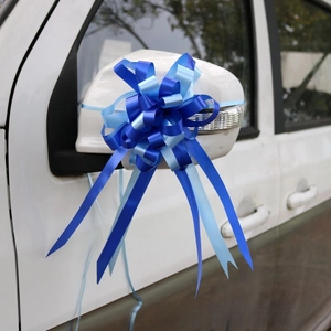 Close-up of blue dual-tone spherical ribbon bow for wedding car door decoration