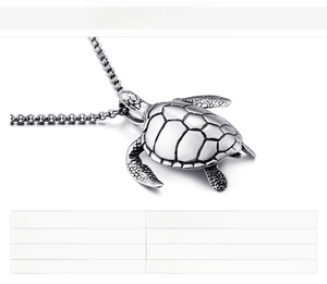 Macro detail of cast stainless steel sea turtle pendant with vintage textured finish
