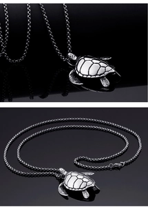 Detailed close-up of a stainless steel sea turtle pendant with intricate shell patterns
