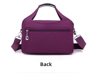 Back view of purple water-resistant nylon bag showing the rear zipper pocket and handles