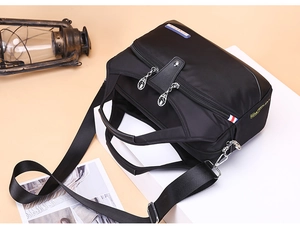 Detail of waterproof nylon shoulder bag with leaf-shaped zipper and adjustable strap