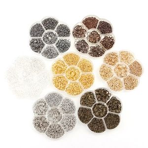 Piccoli anellini di metallo in scatole a fiore per accessori di bigiotteria fai da te.