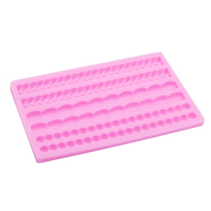 Pink silicone mold featuring various braided rope and pearl bead textures for cake decorating