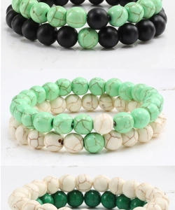 Close-up of colorful stone beaded bracelets with matte black and turquoise textures
