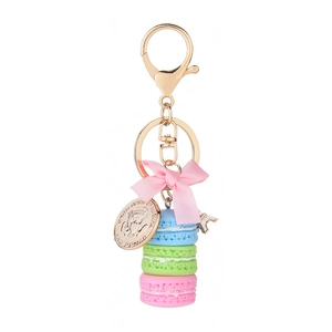 Macaron cake keychain with pink bow and Eiffel Tower charm on a gold metal ring