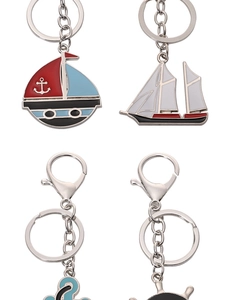 Detail of nautical keychains showing a blue sailboat and anchor with enamel finish