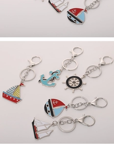 Nautical theme metal keychains featuring enamel sailboat anchor and steering wheel charms