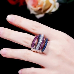 Macro shot of multi-layer silver ring set with white, royal blue and rose red zircons