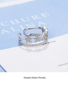 Macro shot of silver double-layer open ring featuring five-pointed stars with pavé zircons
