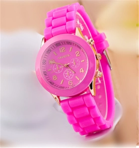 Primo piano dell'orologio Geneva rosa acceso in silicone con numeri arabi dorati e quadranti