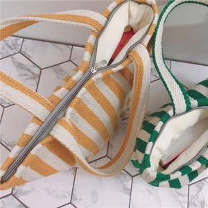 Top view of striped canvas handbags with metal zipper and spacious inner lining