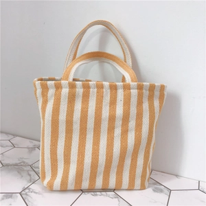 Close-up of yellow and white striped canvas tote showing thick herringbone weave texture