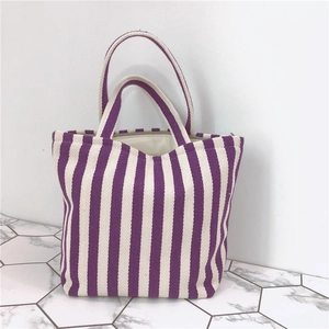 Striped canvas tote bag with purple and white vertical stripes and zipper closure