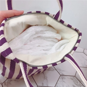 Close-up of striped canvas bag interior showing large capacity for diapers and nursing pads