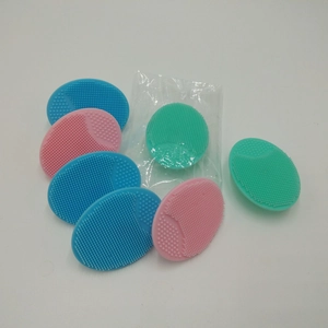 Pile of colorful oval silicone facial cleansing brushes in blue, pink, and mint green