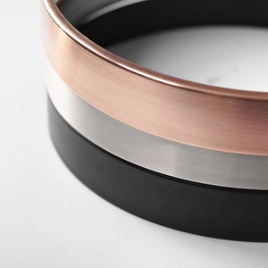 Three-piece set of minimalist metal wall clocks in rose gold, brushed silver, and matte black