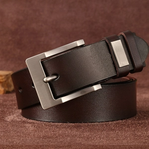 Close-up of brown genuine leather belt with silver metal pin buckle and textured finish