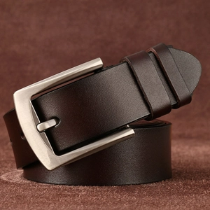 Close-up of rolled brown leather belt featuring a brushed square metal pin buckle