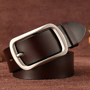 Detail of a dark brown leather belt with a rectangular brushed metal pin buckle