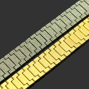 Close-up of hip-hop bracelets featuring a gold textured link and a silver iced-out diamond strap