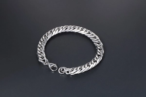 Close-up of a silver stainless steel Cuban link bracelet for men with a lobster clasp