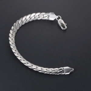 Polished silver stainless steel Cuban link bracelet with lobster clasp on dark background