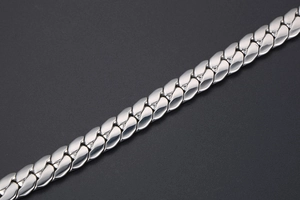 Macro detail of high-polished stainless steel Cuban chain link for men's jewelry