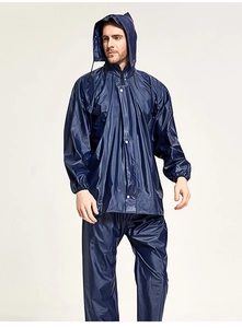 Detail of dark blue waterproof rain suit with hooded jacket and pants for outdoor work