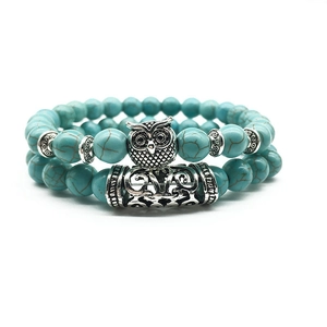 Detailed view of owl charm bead bracelets with turquoise stones and vintage silver accents