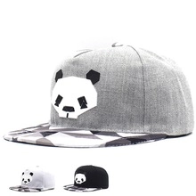 Macro view of panda motif baseball caps showing gray white and black textured fabric detail