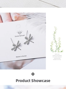 Close-up of dragonfly stud earrings with silver finish and sparkling zircon stones