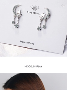 Detail of silver moon and star tassel earrings with shimmering cubic zirconia stones