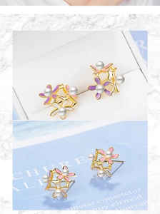 Detail of floral earrings with pink and white enamel petals and central pearls