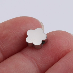 Macro shot of a polished five-petal flower metal bead for DIY jewelry making