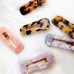 Minimalist geometric acetate hair clip with tortoise shell pattern on soft plush