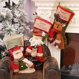 Three vintage Christmas stockings with Santa, reindeer and snowman on fireplace