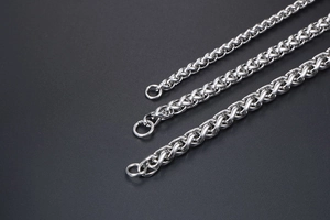 Close-up of three silver stainless steel wheat chains in varying thicknesses for jewelry