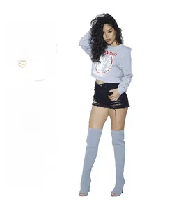 Close-up of stylish black denim shorts with ripped details and frayed hem for women