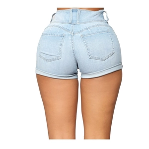 Close-up of high-waist light blue denim shorts with double back pockets and rolled hem