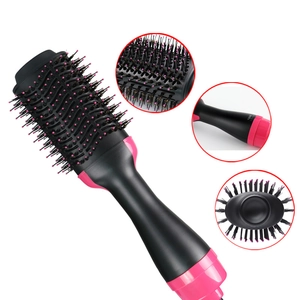 Detail of hot air brush head and rotary temperature control dial on pink and black hair styler