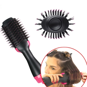 Detail view of multifunctional hot air brush with pink bristles and hair styling scene