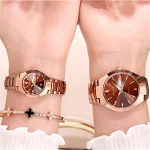 Close-up of ORUSS couple's rose gold quartz watches with brown dial and clover bracelet