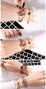 Detail of rose gold quartz watch with calendar and clover bracelet set on female wrist