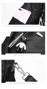 Detail view of water-resistant nylon backpack with bear charm and polished metal buckles