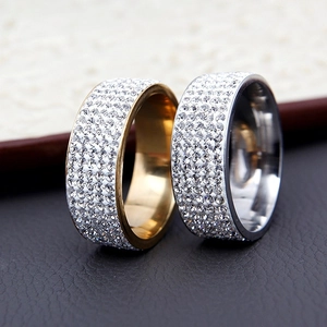 Macro detail of wide titanium steel rings in gold and silver with five rows of pavé diamonds