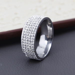 Close-up of silver titanium steel ring with five rows of micro-pave crystals on a book