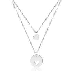 Double-layered silver necklace with heart and round cut-out pendant on white background
